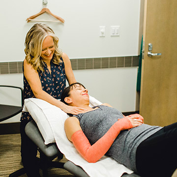 physical therapist massaging patient's neck